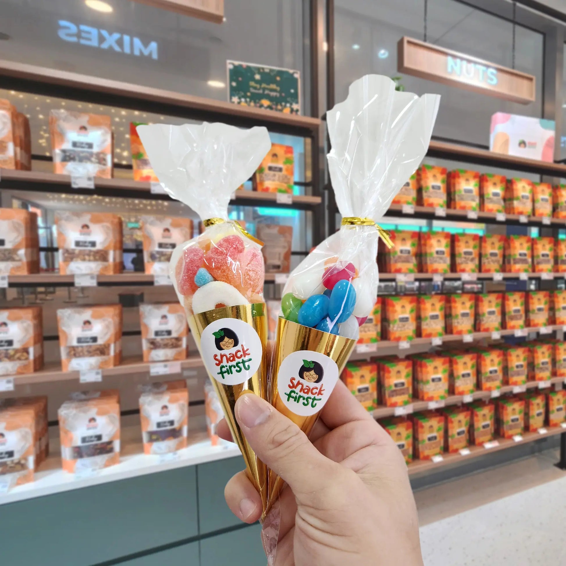 hand holding two snack cones