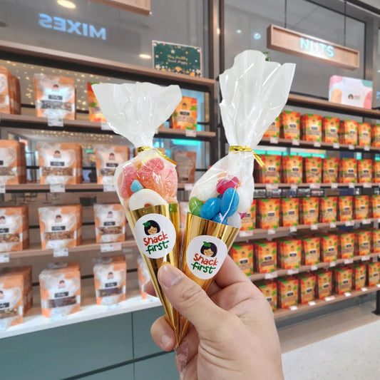 hand holding two snack cones